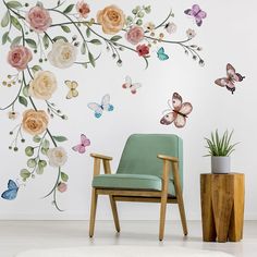 a chair sitting in front of a wall with flowers and butterflies painted on the walls