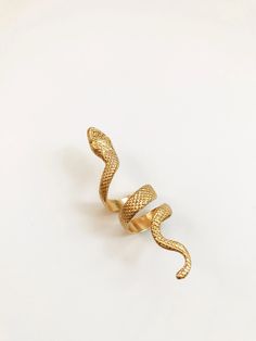 A beautifully engraved 3” snake wrap ring. Historically, serpents and snakes represent fertility or a creative life force. As snakes shed their skin through sloughing, they are symbols of rebirth, transformation, immortality, and healing DETAILS: Brass 3” Long Adjustable Ring Ships with polishing cloth to keep it forever shining. Packaged for gift giving. *Worn with the Nira Ring *Sold individually, not a set. Snake Shedding, Wrap Ring, Snake Ring, Life Force, Wrap Rings, Creative Life, Adjustable Ring, Snakes, Adjustable Rings