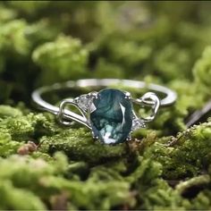 a close up of a ring on moss