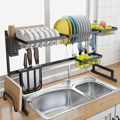 a kitchen sink with dishes and utensils hanging from it's rack over the sink