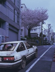 a white car parked on the side of a road