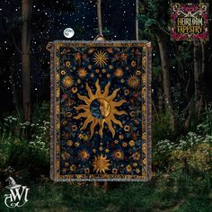 the sun and moon quilt is hanging in front of trees at night with stars on it