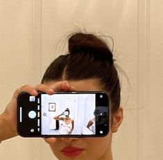 a woman taking a selfie with her cell phone