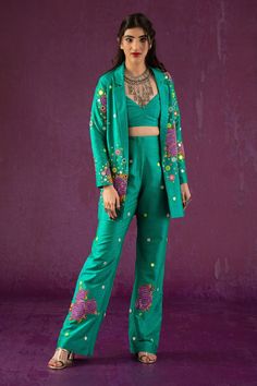 Green lapel collared blazer, elevated with rose pattern and thread embroidery. Comes with flared hem pant and bustier.
Components:3
Pattern:Embroidery
Type of Work:Floral,Mirror
Neckline:Lapel Collar
Sleeve Type:Full Sleeves
Fabric:Dupion Art Silk
Color:Green
Other Details:
V neck bustier
Occasion:Party,Resort - Aza Fashions Function Dresses, Floral Mirror, Pink Suit, Simple Pakistani Dresses, Embroidery Floral, Pattern Embroidery, How To Hem Pants, Indian Fashion Designers, Thread Embroidery