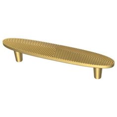 a brass plated metal object with wavy lines on the top, and an oval shaped body