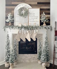 a fireplace decorated for christmas with stockings hanging from the mantel and stockings on top