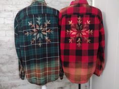 two flannel shirts hanging on a wall