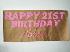 a brown paper bag with pink writing on it that says happy 21st birthday alme