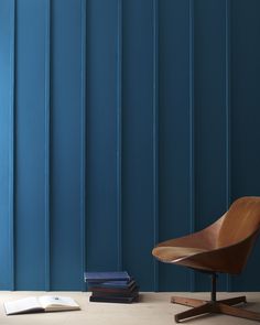 a wooden chair sitting next to a stack of books