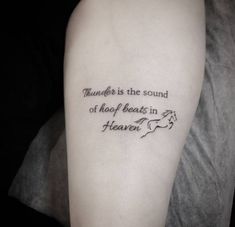 a person with a tattoo on their arm that says thunder is the sound of hoof beats in heaven