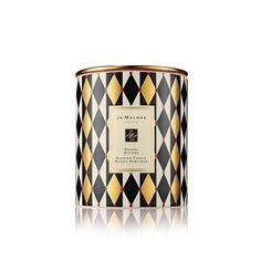 a black and white candle with gold trimmings on the lid, sitting in front of a white background