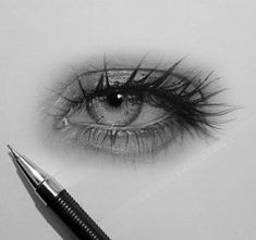 an eye with long lashes is shown next to a fountain pen on a white surface