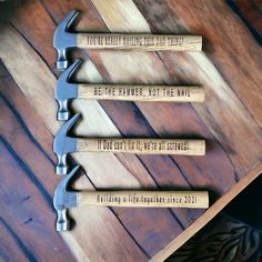 four hammers with words on them sitting next to each other