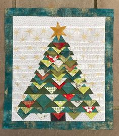 a quilted christmas tree with stars on it