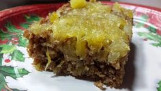 a close up of a piece of cake on a plate with pineapple toppings