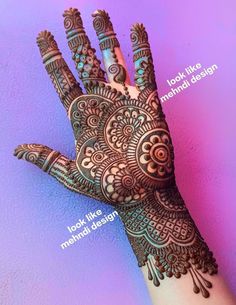 the hand is decorated with henna designs