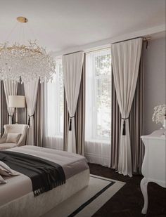 a bedroom with a chandelier hanging from the ceiling and curtains on the windows