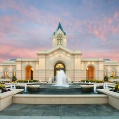 a large building with a fountain in front of it