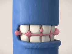 a blue toothbrush holder with teeth and gums on it's sides, in front of a white background