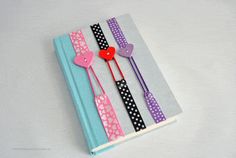 three bookmarks with hearts on them sitting next to each other