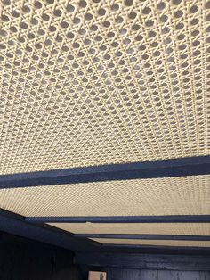 a close up view of the ceiling in a room with wood flooring and white wicker