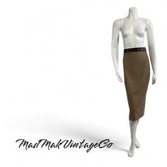 This stunning camel beige pencil skirt by Dolce & Gabbana is a classic from the 1990s. Featuring a sleek silhouette with a back slit, this skirt offers a chic and timeless look. The brown leather waistband and matching small leather pockets add a touch of luxury, while the skirt secures with bold metal snaps. Made in Italy from a high-quality blend of wool, polyester, and other fibers, it is unlined and in excellent condition. Details: Warm camel beige pencil skirt by Dolce & Gabbana Slim skirt Slim Tea, Beige Pencil Skirt, Beaded Skirt, Slim Skirt, Black Maxi Skirt, Tea Length, Couture Dresses, Dolce & Gabbana, Skirt Fashion