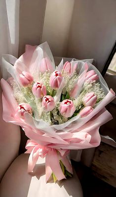 a bouquet of pink tulips and white carnations sits in the passenger seat