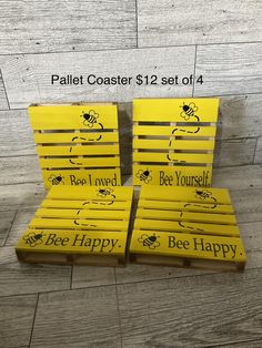 three bee happy pallet coasters sitting on top of each other