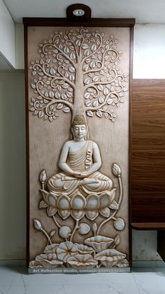 a buddha statue sitting in front of a tree