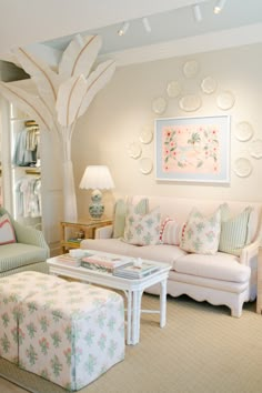 a living room filled with furniture and a tree in the middle of it's wall