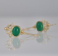 "These 14k gold dangle earrings and green Onyx gemstone are beautiful hanging earrings that you can buy as a gift for you or for a friend. You will love the gold and green color combination of these gemstone earrings. The solid gold and the green Onyx stone are so beautiful together that you will want to look at all the time :-) These gemstone earrings can be made with other type of stones end every new combination is a surprise for me. I can make these earrings in 14k roes gold. The earrings ar Elegant Jade Earrings For May Birthstone, Elegant Green Cabochon Earrings, Elegant Green 14k Gold Earrings, Emerald Cabochon Earrings As A Gift, Emerald Cabochon Earrings For Gift, Elegant Cabochon Jewelry For May Birthstone, Fine Jewelry Green Cabochon Earrings, Elegant Yellow Gold Jade Earrings, Elegant Jade Earrings Gift