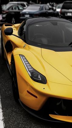 a yellow sports car parked in a parking lot