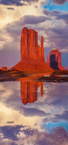 the desert is reflected in the still water