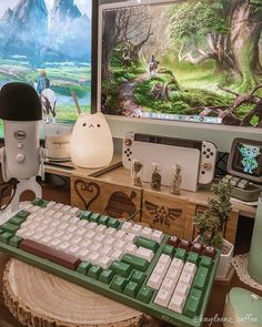 a computer keyboard sitting on top of a wooden table next to a monitor and mouse