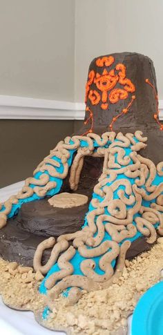 a cake that is shaped like an oven with blue and orange icing on it