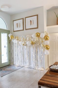 balloons and streamers are hanging from the wall in front of a door with an entry way