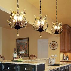 a kitchen with an island and chandelier hanging from the ceiling