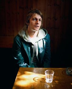 a man sitting at a table in the dark