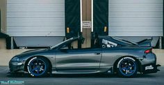 a car parked in front of a garage door