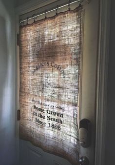 a window with a curtain that reads, home grown in the south since 1908