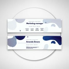 two white and blue business cards sitting on top of a circular plate with the words marketing manager