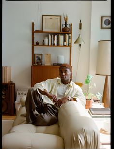 a man sitting on top of a white couch