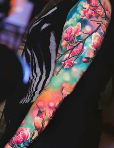 a woman's arm with flowers painted on it