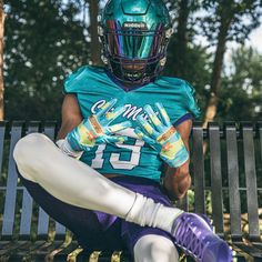 a man sitting on top of a bench wearing a football uniform and holding a glove