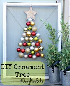 a christmas tree made out of tinsel and ornaments in front of a door with the words diy ornament tree on it