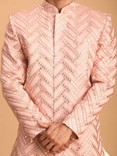 Vastramay Men's Pink Mirror Indo Western Sherwani Top Stand out in style with this stunning pink sherwani top featuring intricate mirror work. It's the perfect blend of tradition and modern design, ideal for festive occasions or special events . Key Features Eye-catching pink color Beautiful mirror work embellishment Mandarin collar for a sophisticated look Full-front button placket for easy wear Long sleeves for a polished finish Specifications Sleeve Length - Long Sleeves Shape - Straight Top