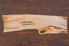 a piece of wood sitting on top of a wooden table