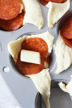 some food is in a muffin tin and ready to be baked into the oven