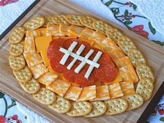 a football shaped cheese platter with crackers