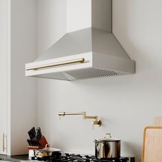 a stove top oven sitting inside of a kitchen next to a cutting board and knife holder